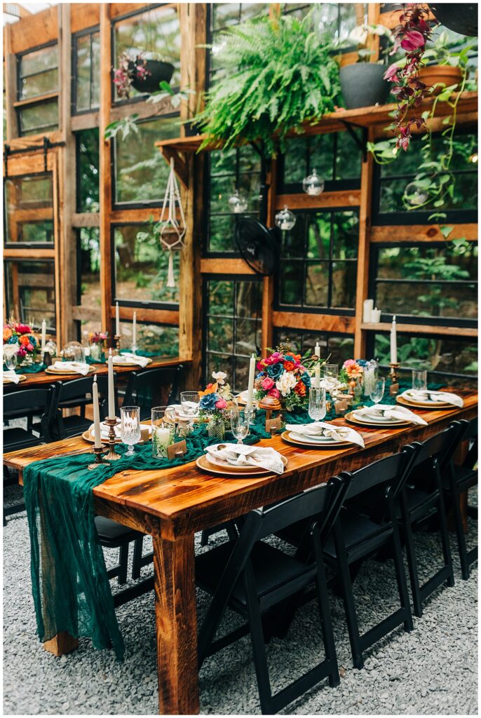 Long farmhouse table set for Kali and Davis’s wedding dinner at Wildflower Farm in Friendsville